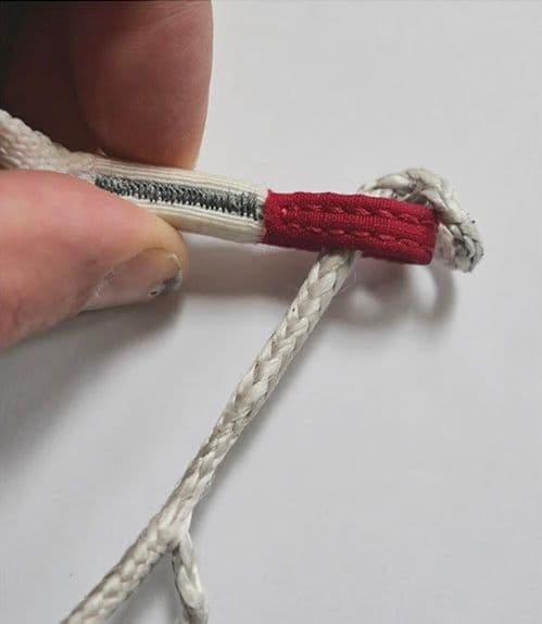 4. Pass the red chest strap loop through the dyneema ABS loop.